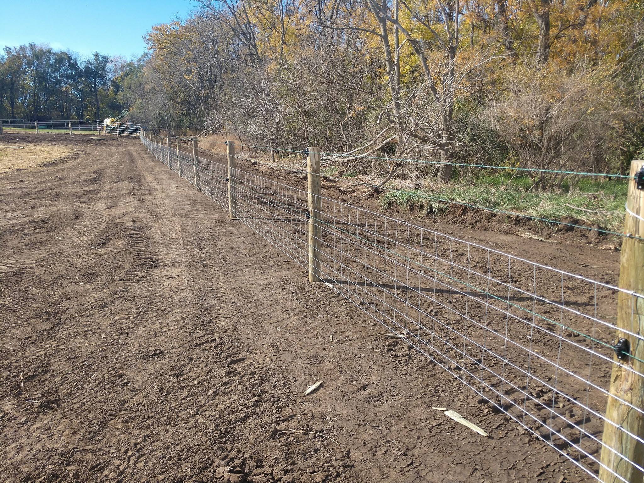 Woven wire and gates along a farm lane in the fall